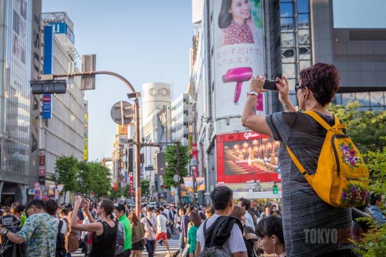 people trying to photograph shibuya crossing
