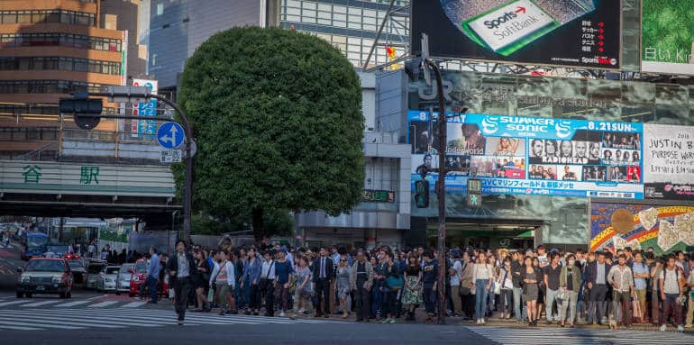 People queue to cross Shibuya scramble crossing