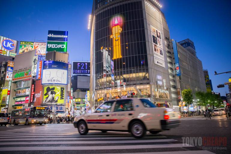 taxi at night on shibuya crossing