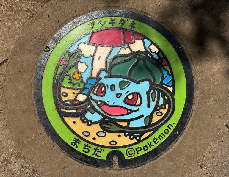 Blue and green Pokémon manhole cover
