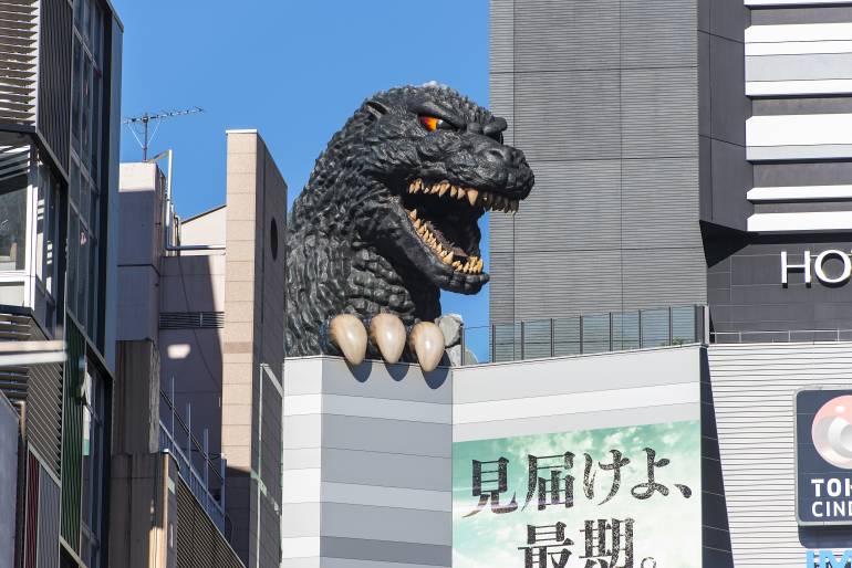 Godzilla head peaking over skyscrapers in Tokyo's Shinjuku district