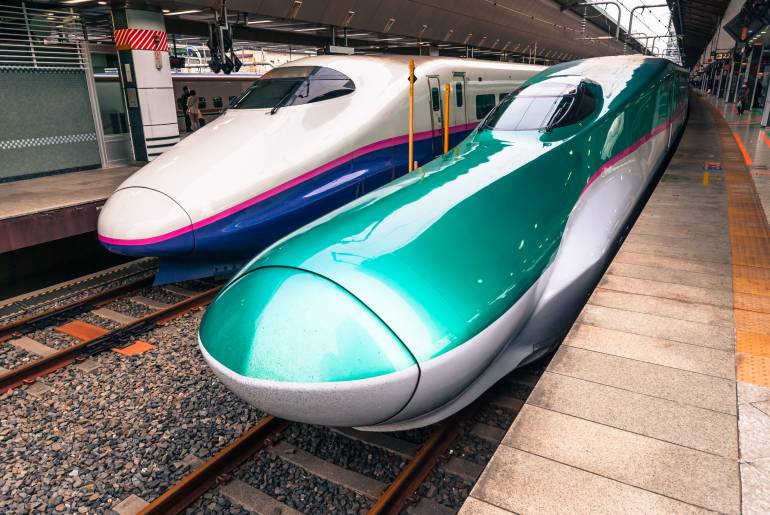 Two different shinkansen at a train station