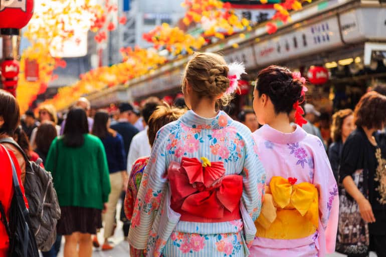 unidentified foreigner tourist wearing kimono, the national tradition costume of Japan walking at Sensoji temple the famous temple in Tokyo, Japan
