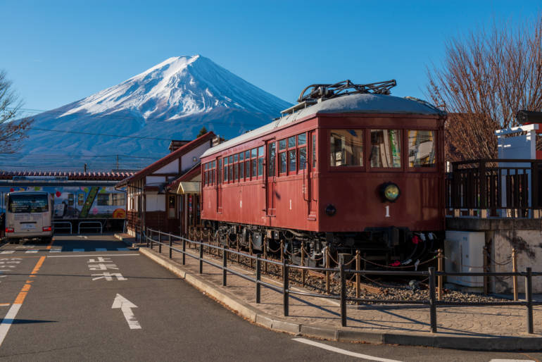 kawaguchiko station near mount fuji, with train in foreground