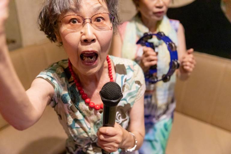 Senior women enjoying Karaoke