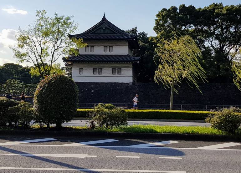 Jogger passes in front of a building of the Imperial Palace