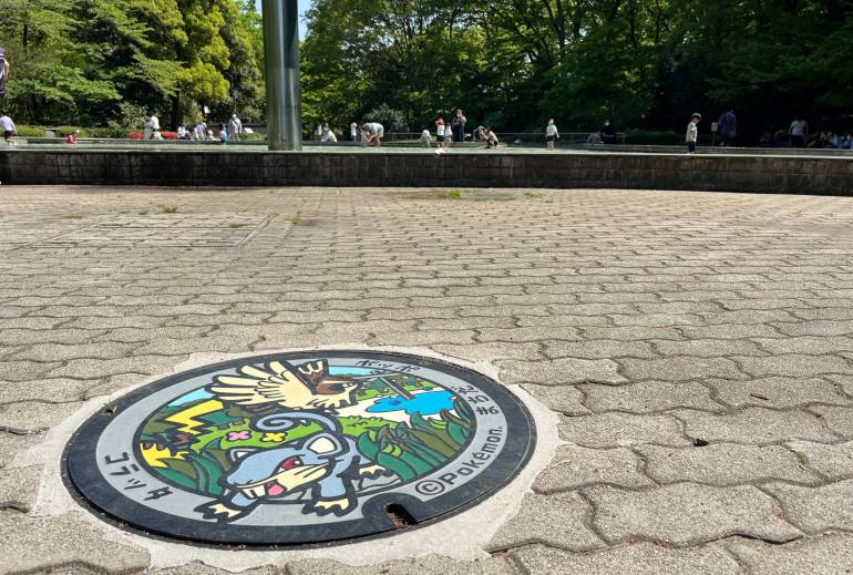 Pokémon manhole cover and surrounding concrete