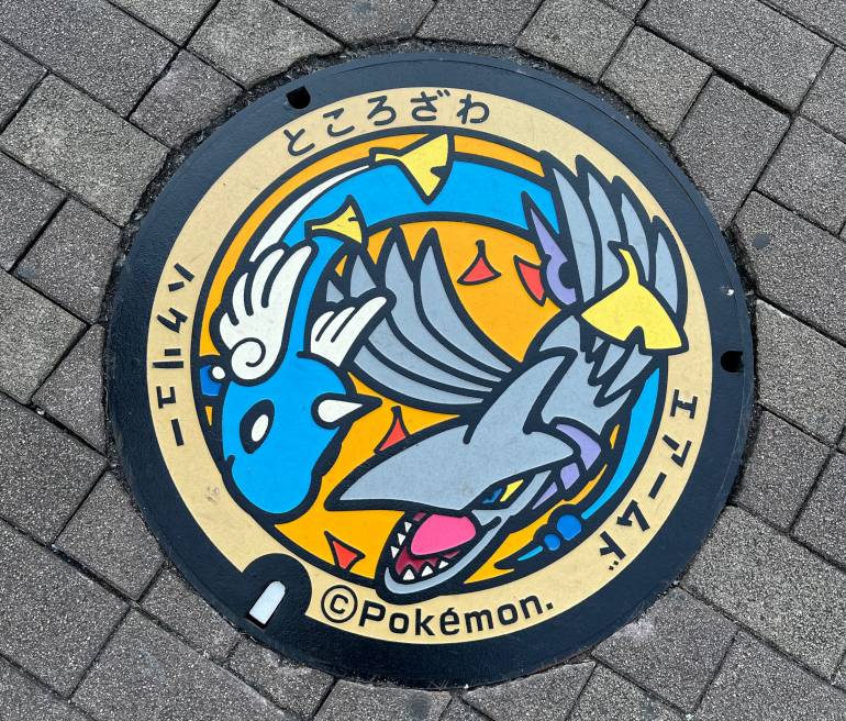 Colourful manhole cover with two Pokémon characters