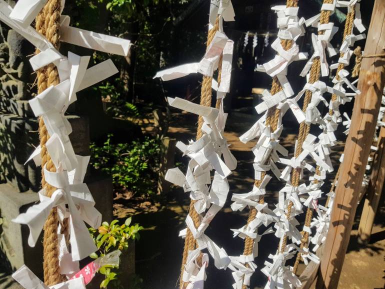 Shrine omikuji tied to a string